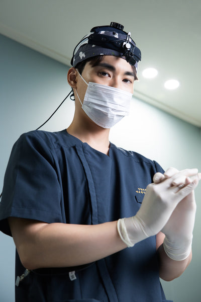 Dr. Donghyun Youn preparing for a clinical procedure