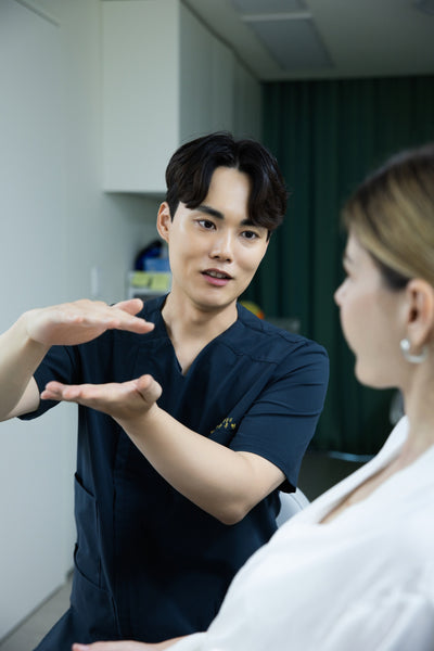 Dr. Donghyun Youn consulting with a patient