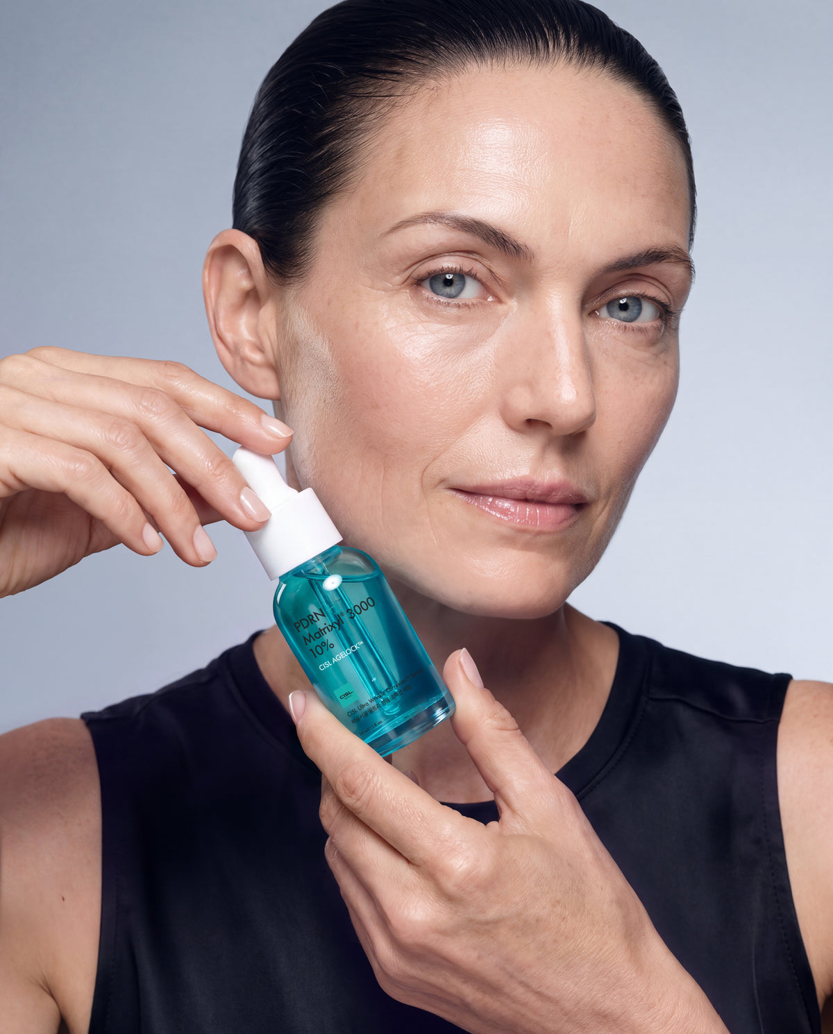 Mature woman holding CISL Ultra Serum